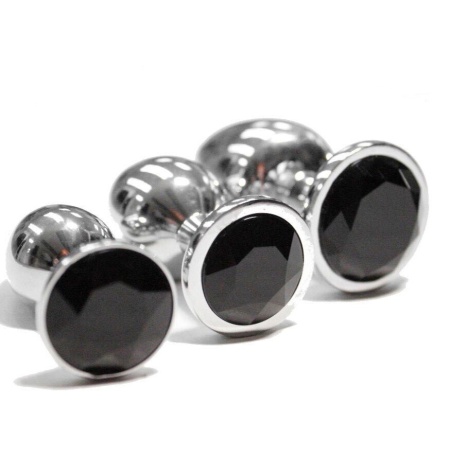 Image d'un ensemble de plugs anal en métal, set de 3 pièces, couleur argent avec pierre noire