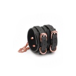 Bondage Couture ankle cuffs from NS Novelties in black leatherette with gold-tone metal detailing